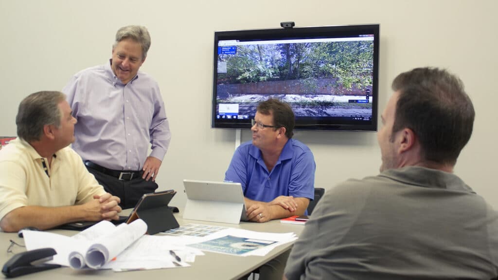 Four men discussing commercial property management