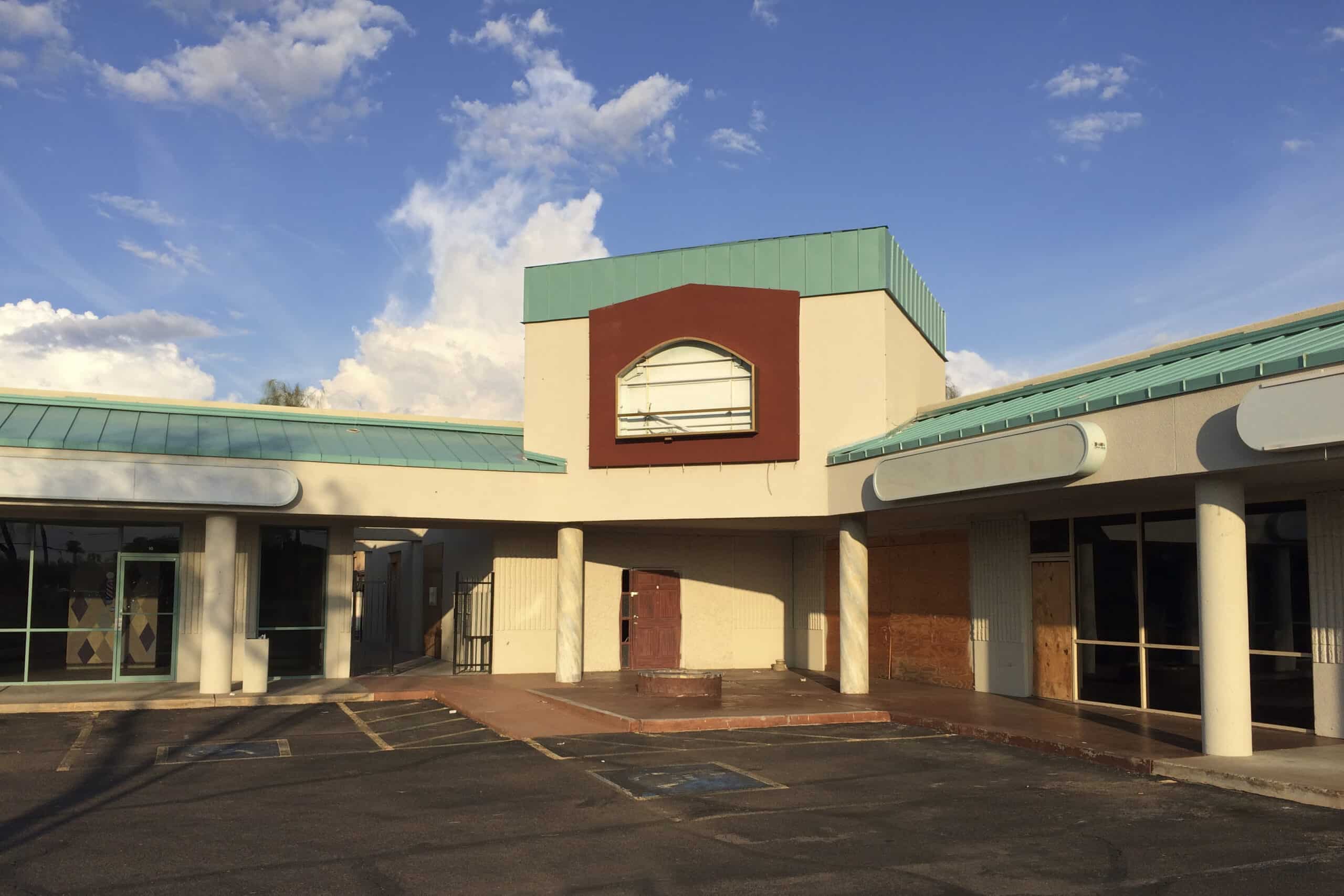 distressed shopping center with vacant stores