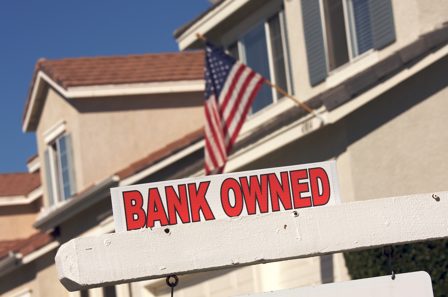 bank owned tag on house sale sign